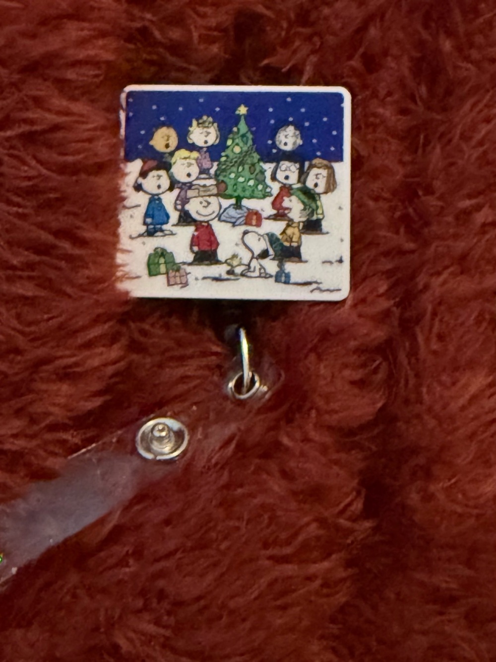 Peanuts Holiday Badge Reel with Red and Blue Caroling Scene